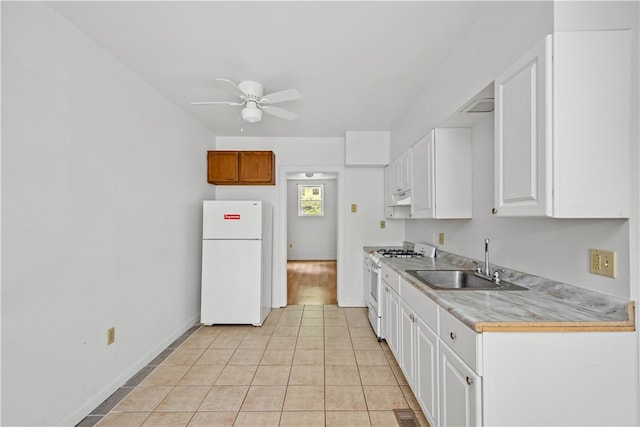 kitchen with light tile patterned flooring, white cabinets, white appliances, ceiling fan, and sink