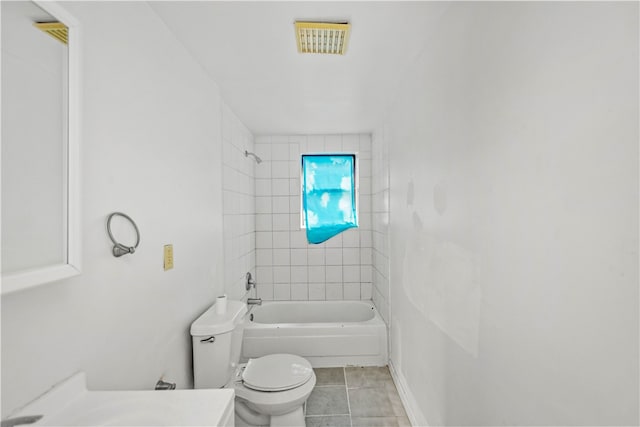 full bathroom featuring vanity, tiled shower / bath combo, toilet, and tile patterned flooring