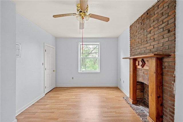 unfurnished living room with light hardwood / wood-style floors, ceiling fan, and a fireplace