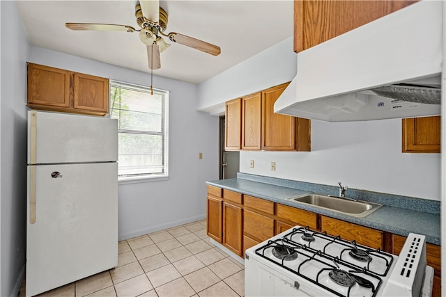 kitchen with white appliances, light tile patterned floors, range hood, ceiling fan, and sink