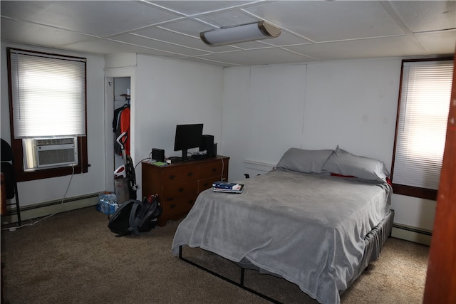 bedroom featuring multiple windows, carpet flooring, and a baseboard radiator