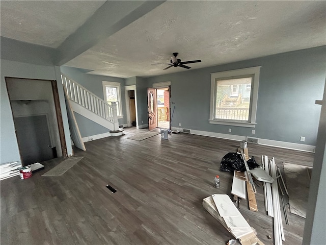 interior space with ceiling fan, a textured ceiling, and dark hardwood / wood-style flooring