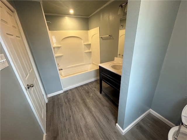 full bathroom featuring bathtub / shower combination, hardwood / wood-style flooring, crown molding, vanity, and toilet