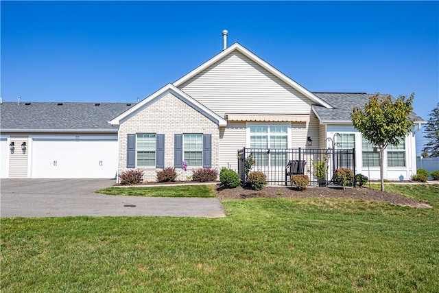 ranch-style house featuring a garage and a front lawn