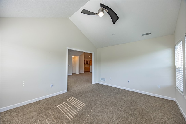 empty room with ceiling fan, carpet flooring, and high vaulted ceiling