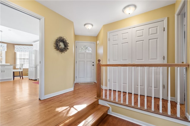 foyer featuring light hardwood / wood-style flooring and a notable chandelier