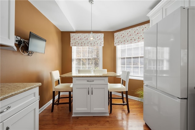 dining room featuring a healthy amount of sunlight and light wood-type flooring