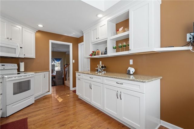 kitchen featuring light hardwood / wood-style floors, white cabinets, and white appliances