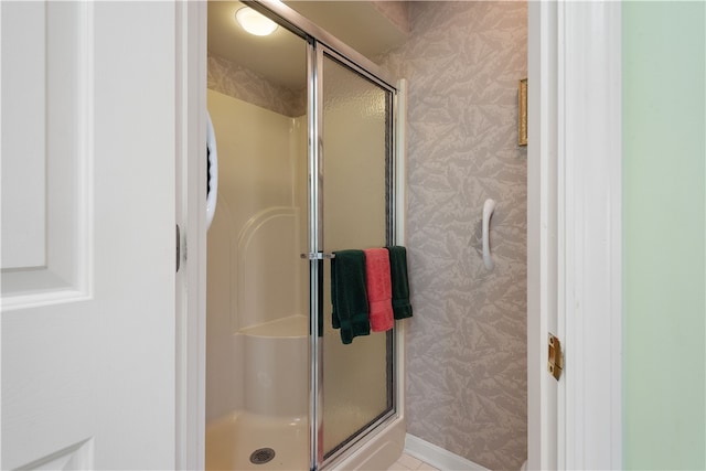 bathroom with a shower with shower door