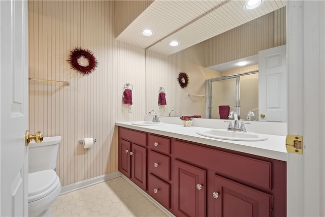 bathroom with a shower with door, toilet, tile patterned flooring, and vanity