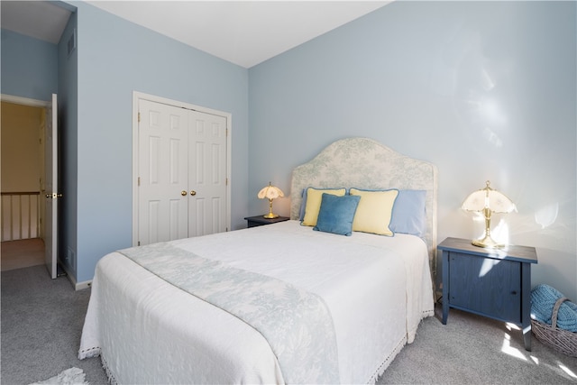 bedroom featuring light carpet and a closet