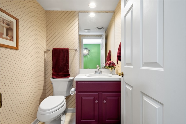 bathroom featuring vanity, toilet, and tile patterned flooring