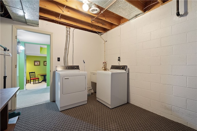 laundry area featuring dark colored carpet and washing machine and dryer