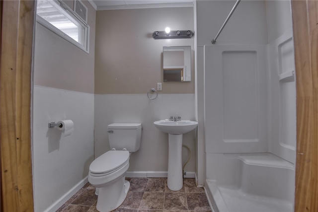 bathroom featuring a shower, sink, and toilet