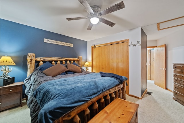 carpeted bedroom with ceiling fan and a closet