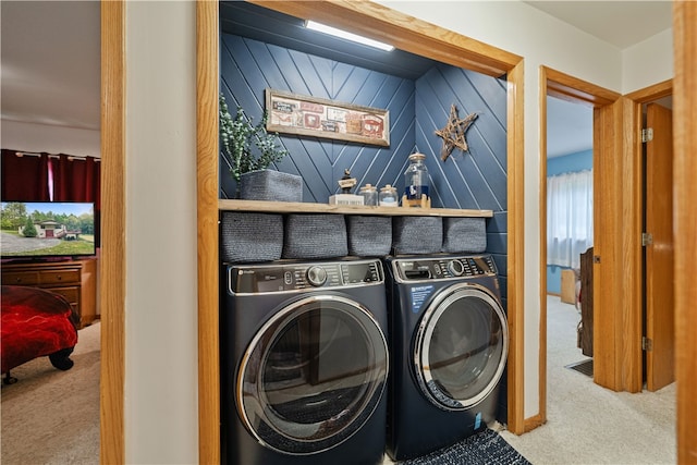 washroom with wooden walls, independent washer and dryer, and carpet floors