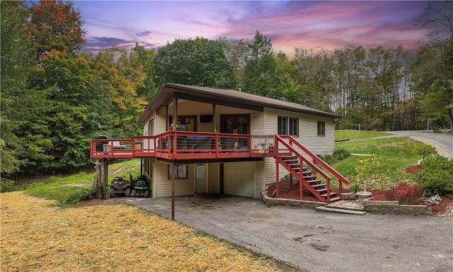 view of front of house with a deck and a yard