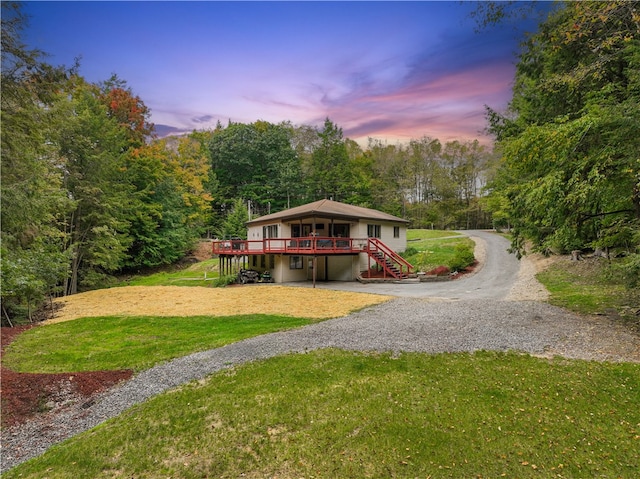 view of front of house featuring a lawn and a deck