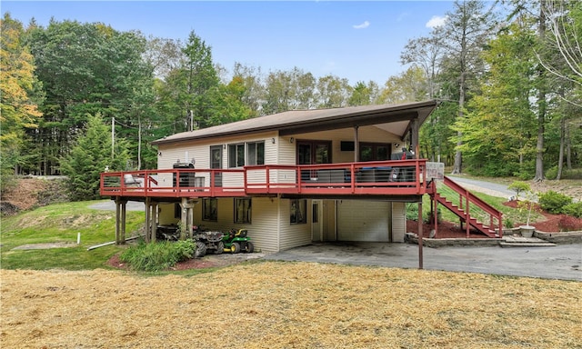 back of property featuring a deck and a yard