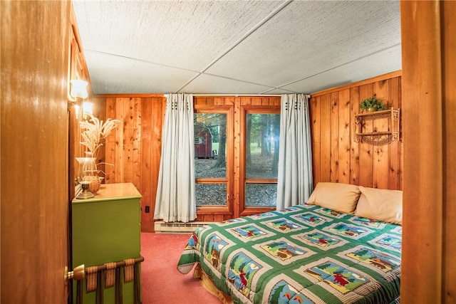 carpeted bedroom with wood walls