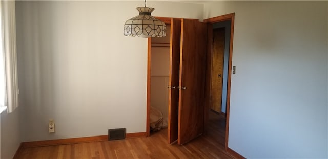 unfurnished bedroom with wood-type flooring