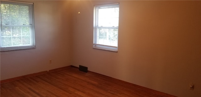 spare room with hardwood / wood-style flooring