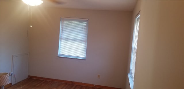 spare room featuring hardwood / wood-style flooring and a wealth of natural light