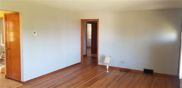 unfurnished room with hardwood / wood-style flooring