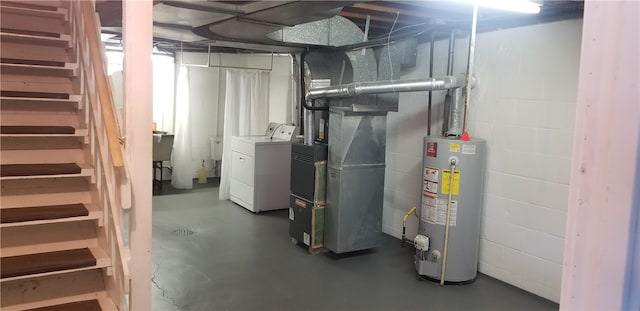 basement featuring water heater, heating unit, and independent washer and dryer