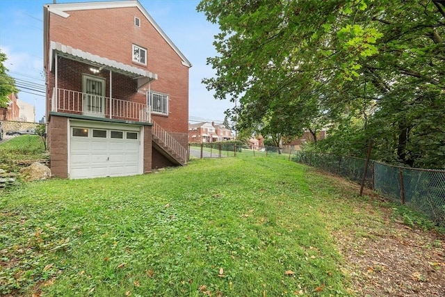 exterior space featuring a garage and a yard