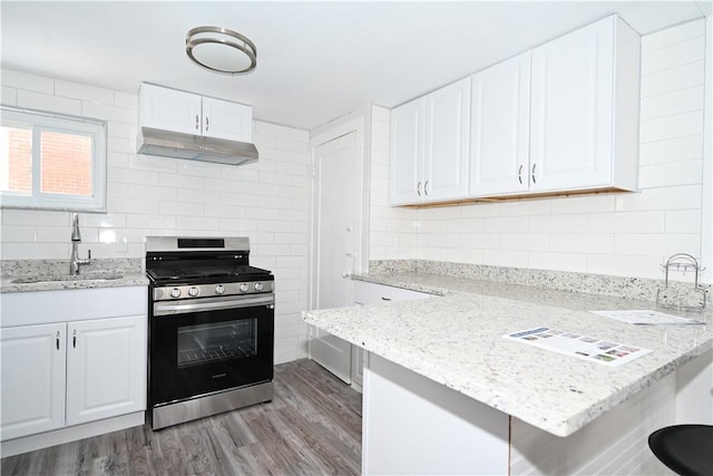 kitchen with white cabinetry, sink, stainless steel range oven, and light wood-type flooring