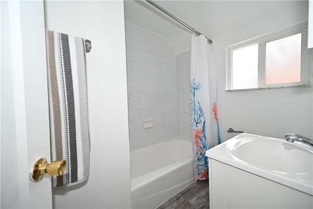 bathroom with shower / bath combo and wood-type flooring