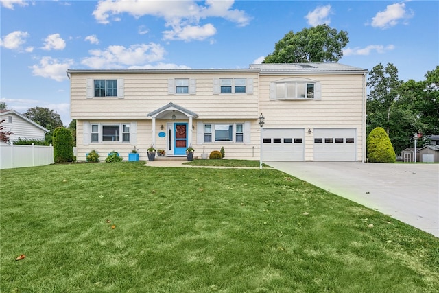 view of front of house with a front yard and a garage