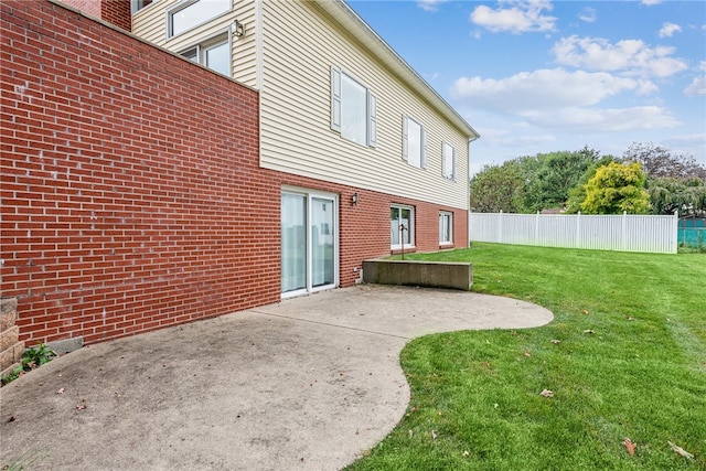 rear view of property featuring a patio and a yard