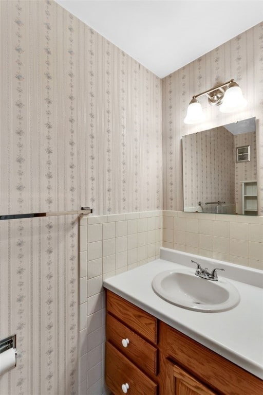 bathroom featuring tile walls and vanity