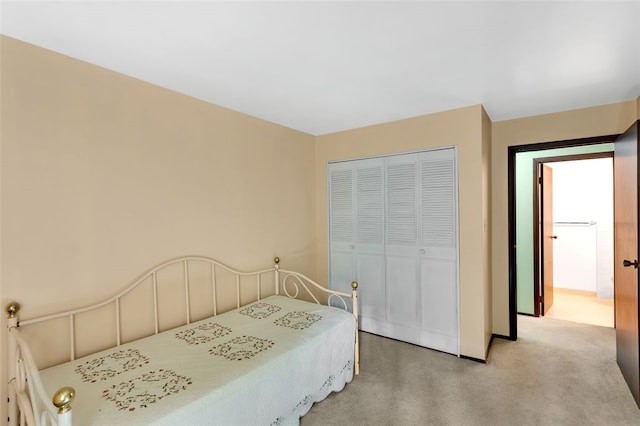 bedroom featuring a closet and light colored carpet