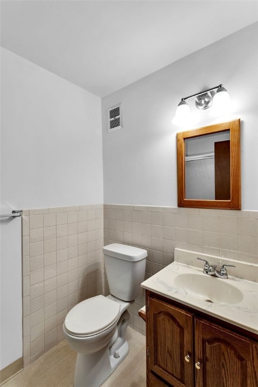 bathroom featuring tile walls, tile patterned flooring, vanity, and toilet