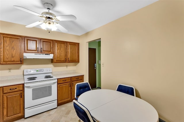 kitchen featuring electric stove and ceiling fan