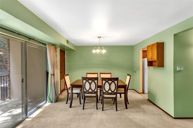 carpeted dining room featuring a notable chandelier