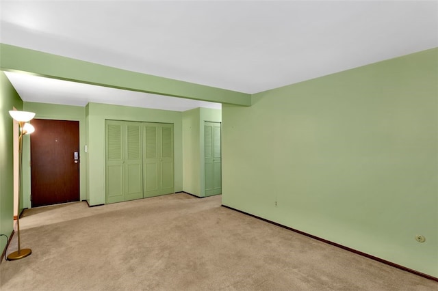 unfurnished bedroom featuring light colored carpet