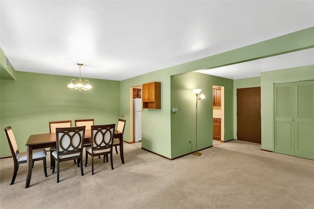 dining space with light carpet and a notable chandelier