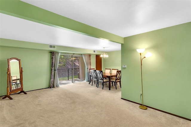 interior space featuring light colored carpet and a notable chandelier