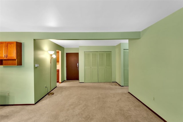 unfurnished room with light carpet