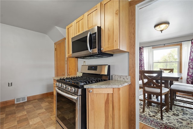 kitchen featuring light brown cabinets and stainless steel appliances