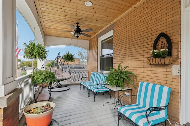 deck with ceiling fan and covered porch