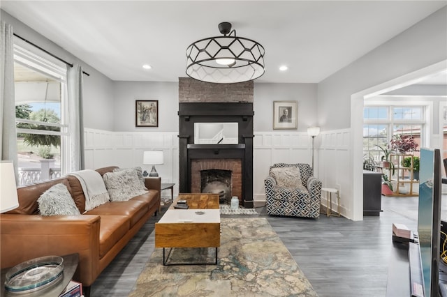 living room with dark hardwood / wood-style floors and a fireplace