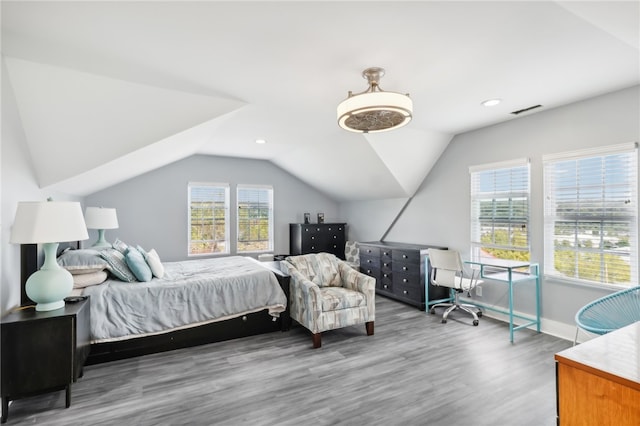 bedroom with lofted ceiling and hardwood / wood-style flooring