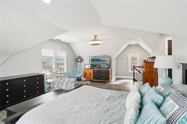 bedroom with lofted ceiling and dark hardwood / wood-style flooring