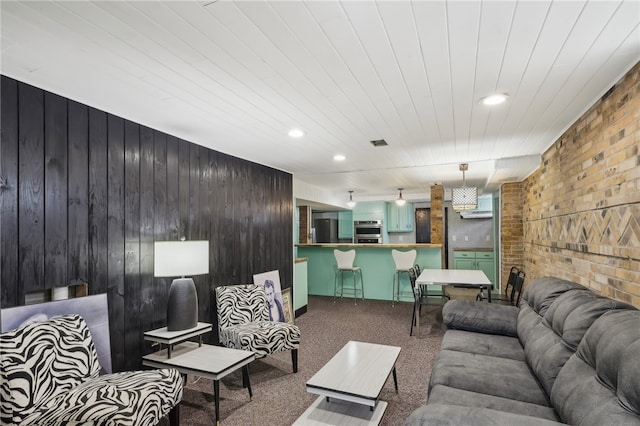 carpeted living room with wooden walls