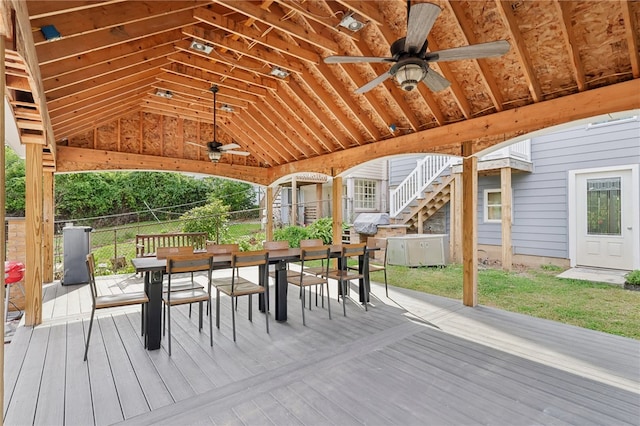 wooden deck with a yard and ceiling fan